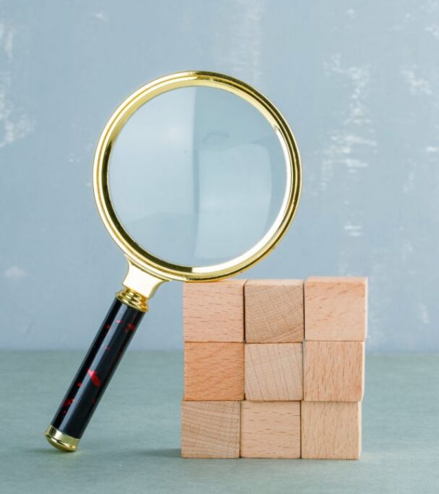 conceptual-search-with-wooden-blocks-magnifying-glass-side-view-min-1024x683